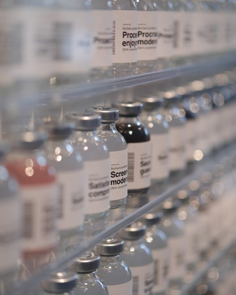 Bottles of water are lined up on a shelf